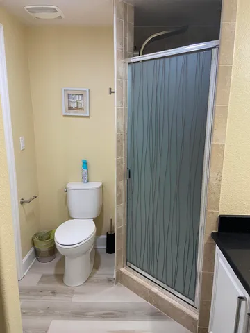 a bathroom with a toilet and a shower curtain