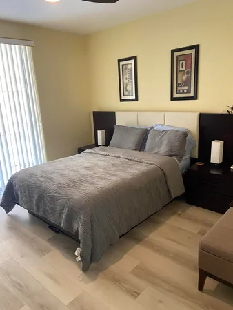 a bedroom with a bed and painting on the wall