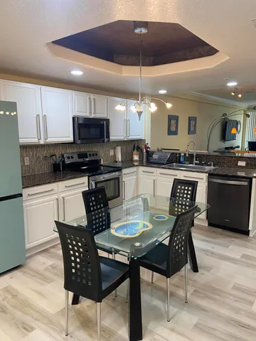 a kitchen with a dining table and chairs