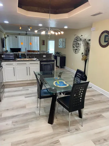 a kitchen with a dining table chairs and view kitchen
