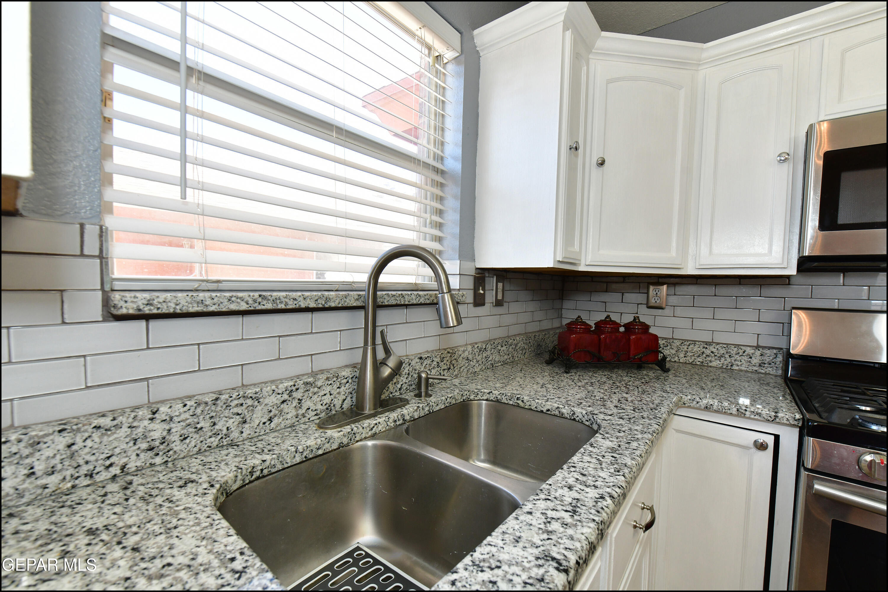 12232 Tierra Rosa Way El Paso, TX 79938 - Photo 12 of 34 a kitchen with a sink and a stove top oven