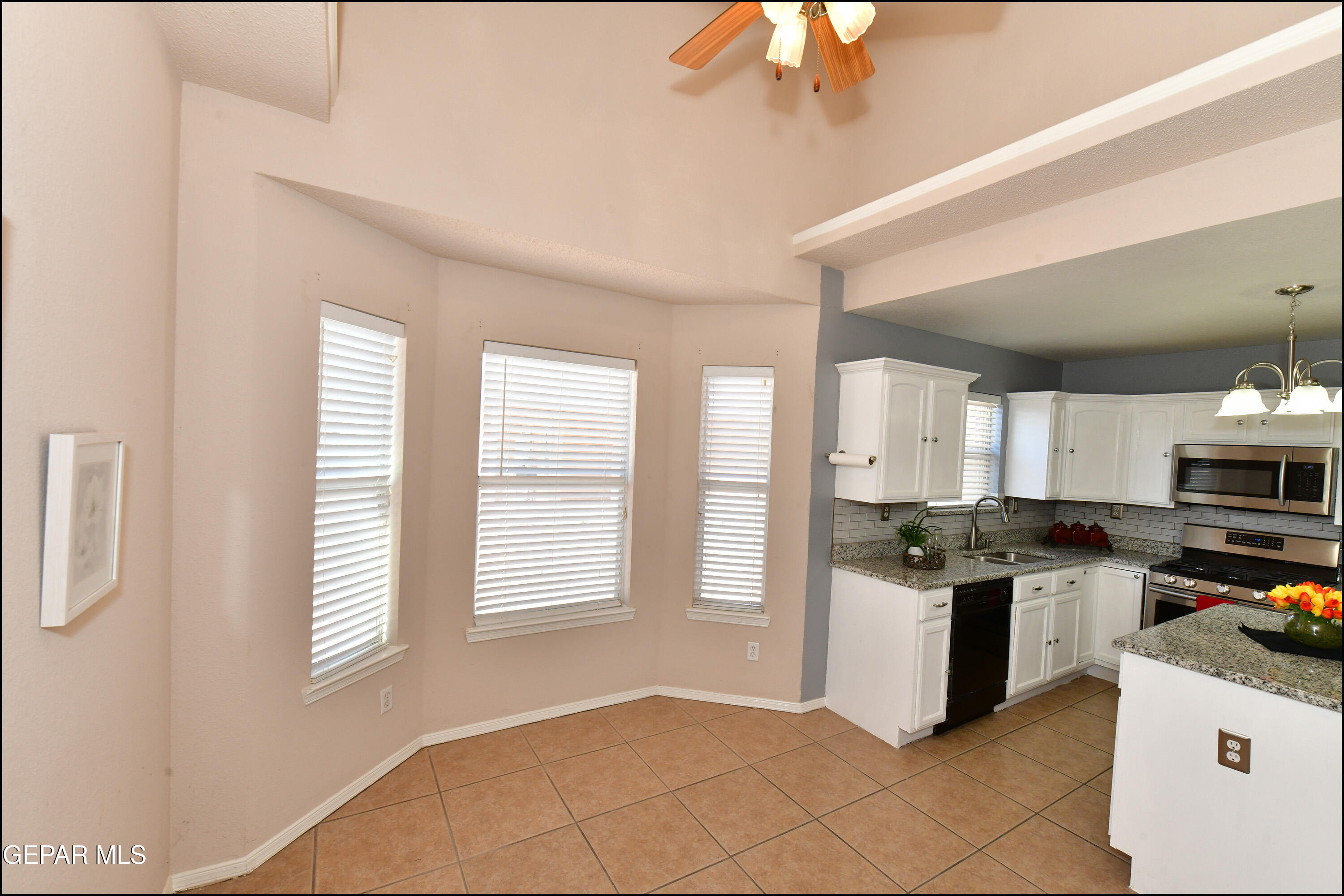 12232 Tierra Rosa Way El Paso, TX 79938 - Photo 14 of 34 a kitchen with stainless steel appliances granite countertop a stove a sink and a refrigerator