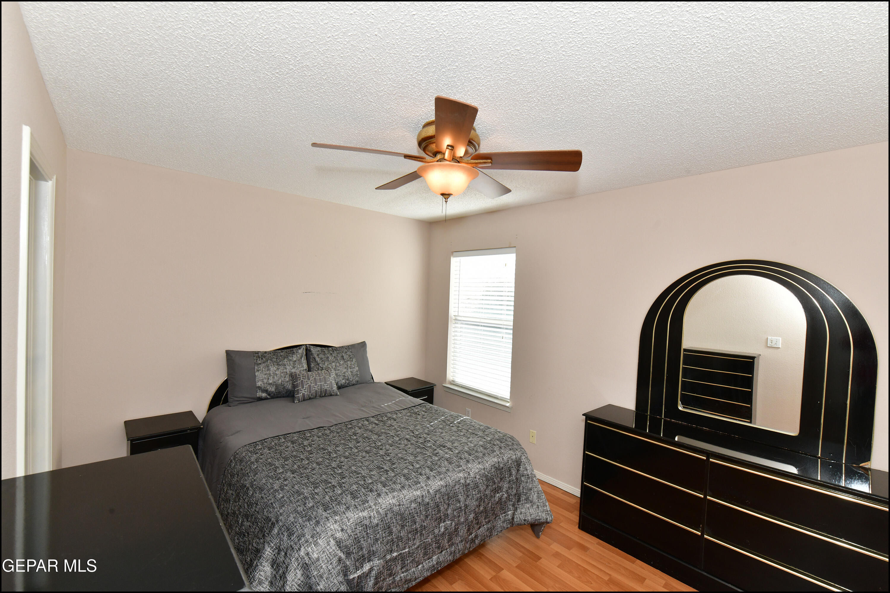 12232 Tierra Rosa Way El Paso, TX 79938 - Photo 15 of 34 a bedroom with a bed and a chandelier