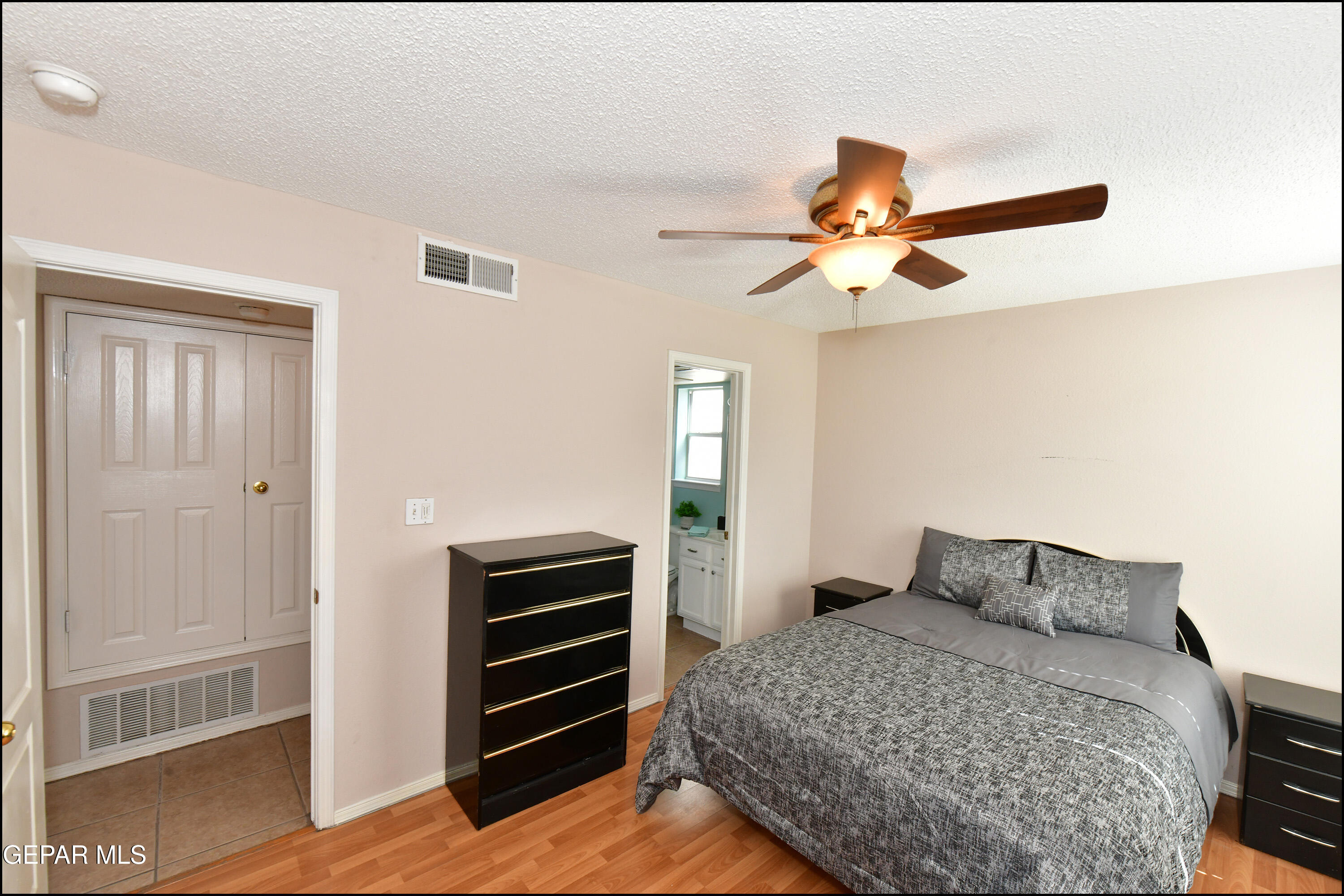 12232 Tierra Rosa Way El Paso, TX 79938 - Photo 16 of 34 a bedroom with a bed and a chandelier fan
