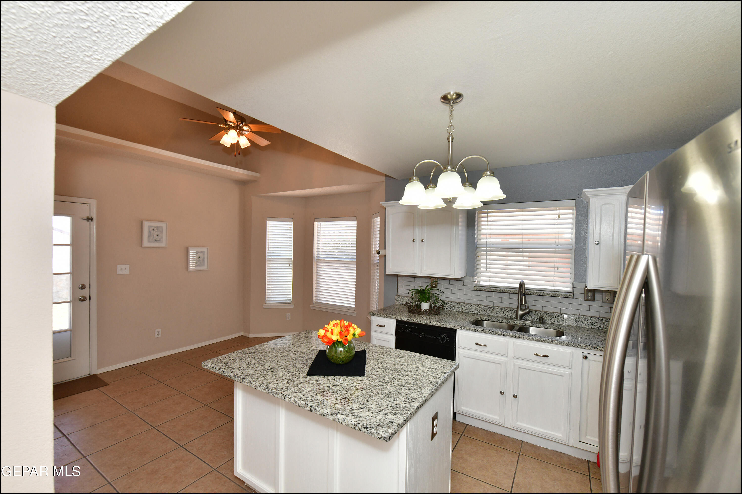 12232 Tierra Rosa Way El Paso, TX 79938 - Photo 7 of 34 a kitchen with stainless steel appliances granite countertop a sink stove and refrigerator