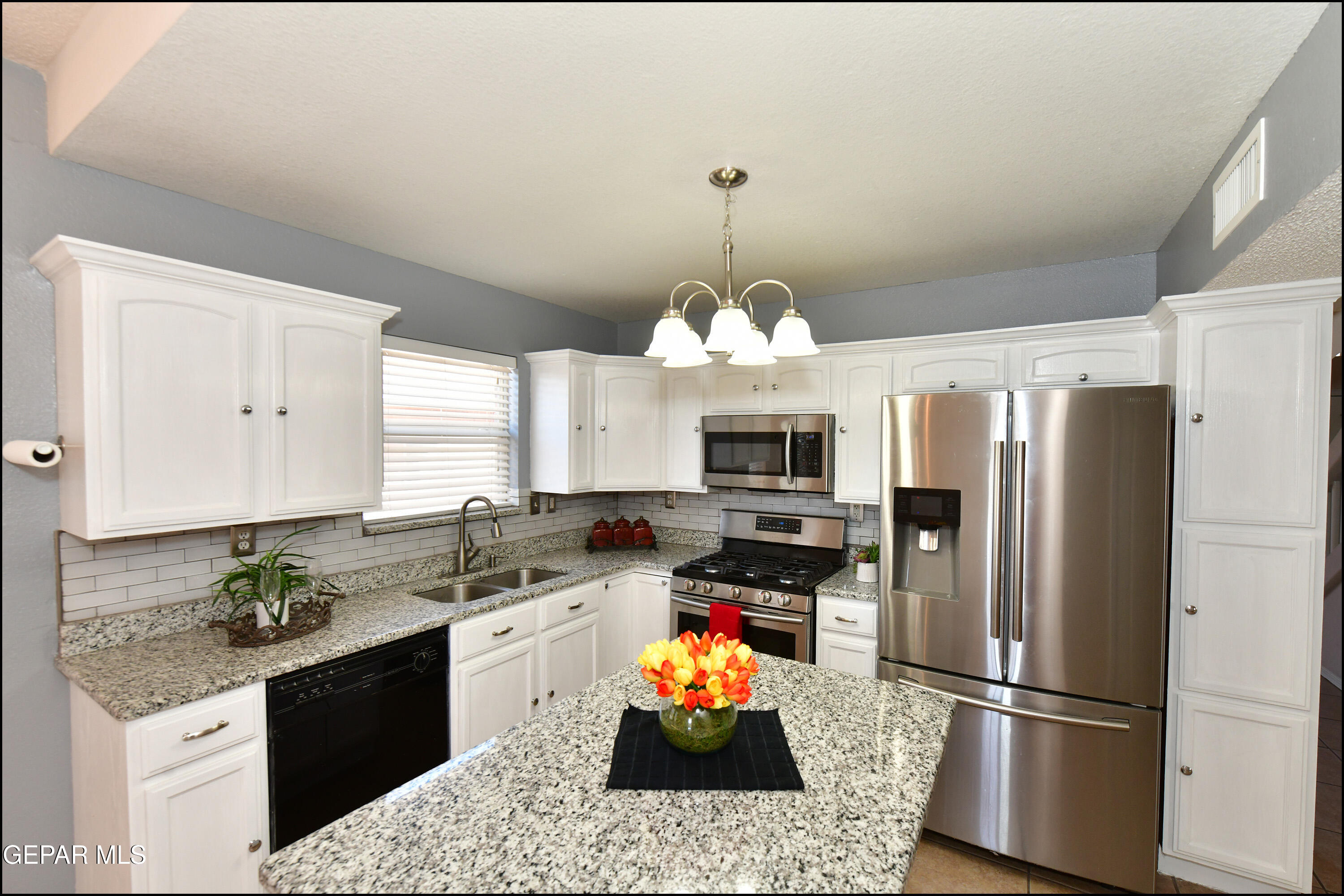 12232 Tierra Rosa Way El Paso, TX 79938 - Photo 8 of 34 a kitchen with stainless steel appliances granite countertop a refrigerator stove and sink