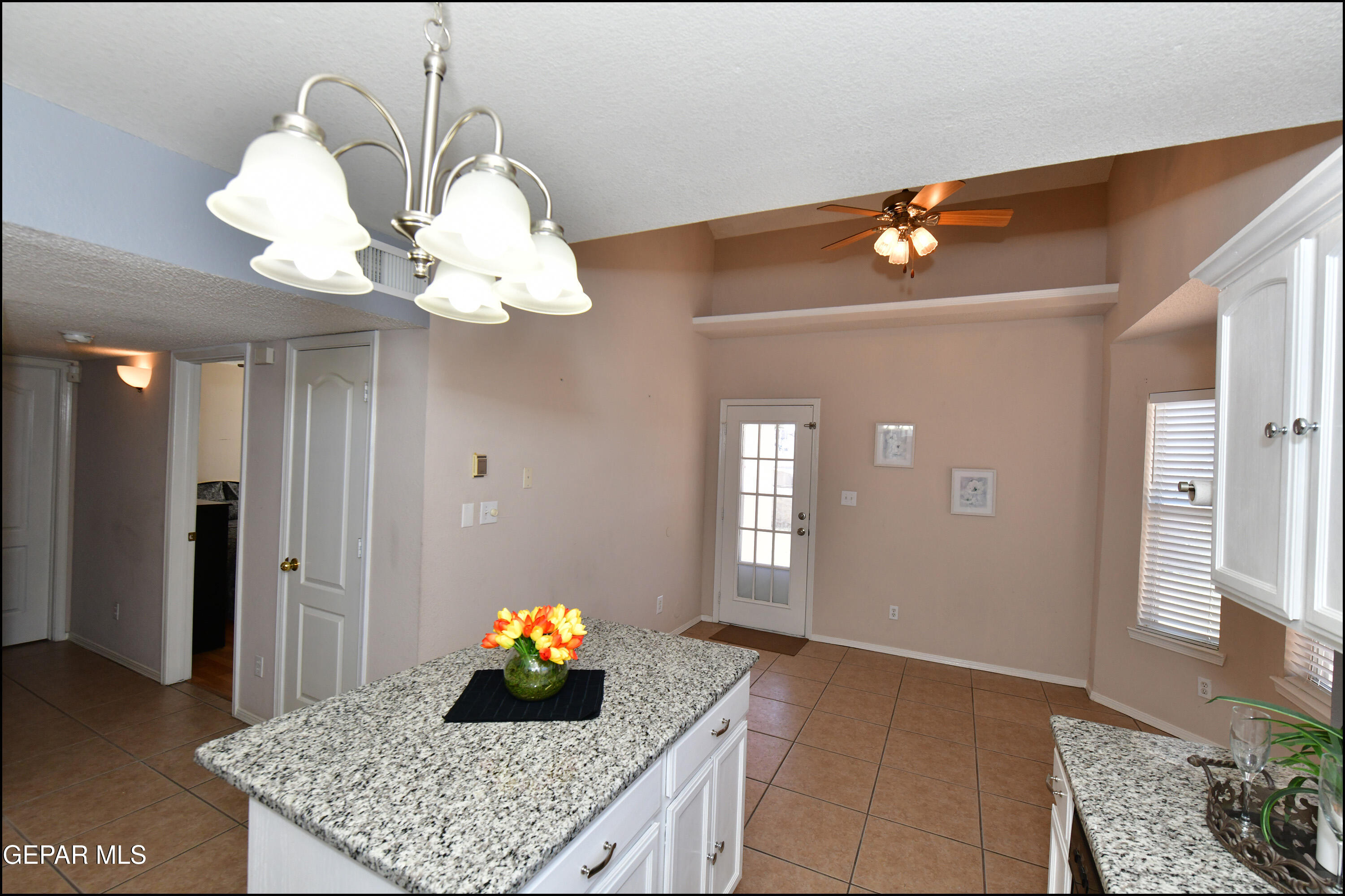 12232 Tierra Rosa Way El Paso, TX 79938 - Photo 10 of 34 a living room with a chandelier and fireplace