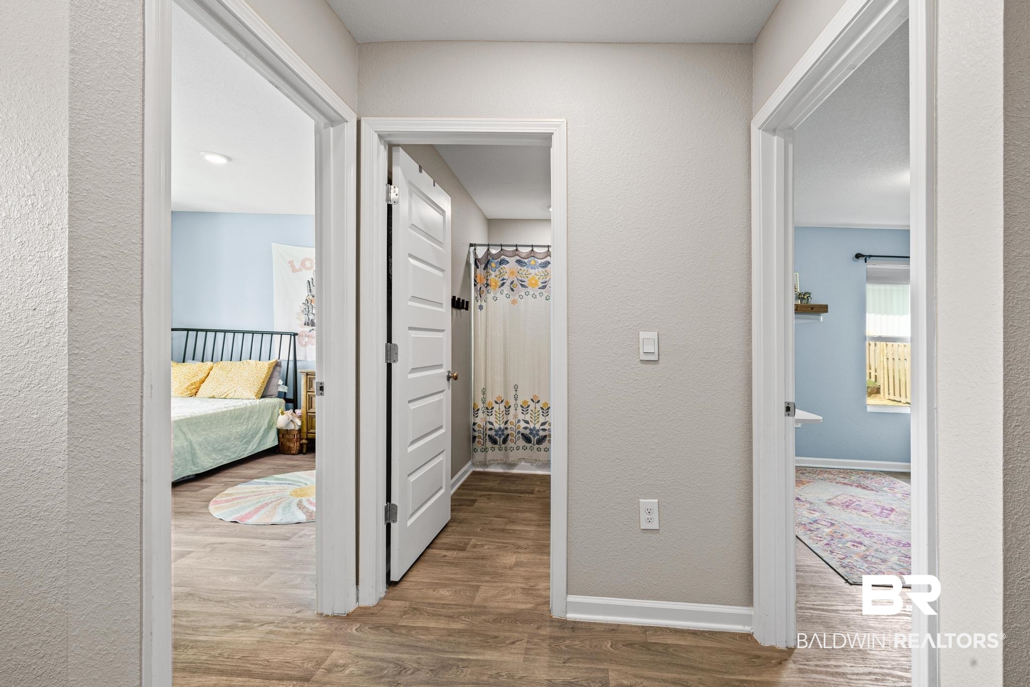 3078 Camino Real Loop Lillian, AL 36549 - Photo 14 of 51 Corridor with wood finished floors and a textured wall