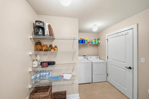 a kitchen with a refrigerator sink and cabinets