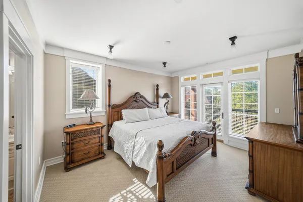 a large bathroom with a double vanity sink a large mirror and a bathtub