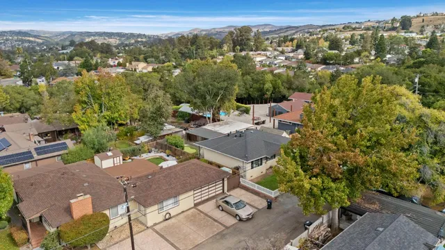 an aerial view of a house with a yard