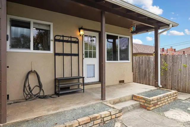 a wooden bench sitting in front of a building