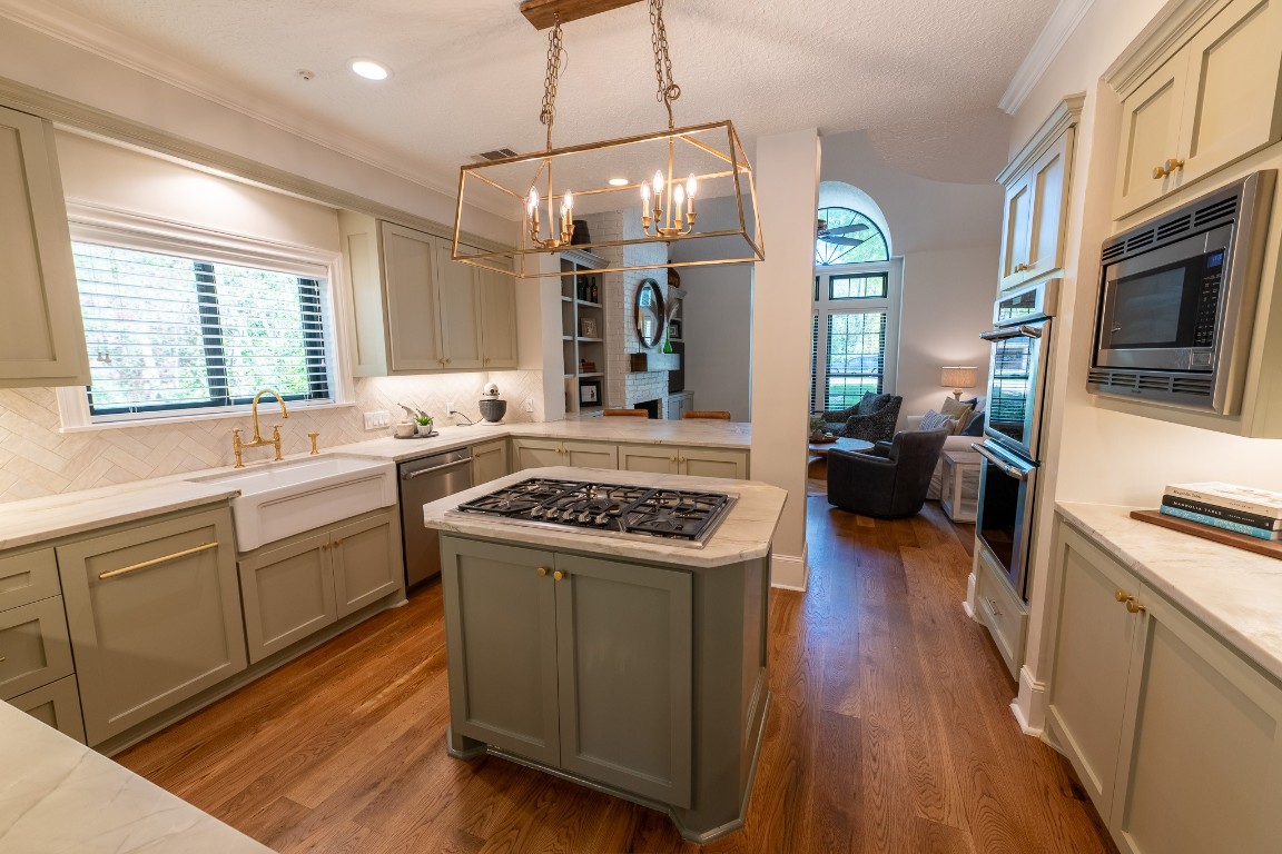 6 Red Sable Point The Woodlands, TX 77380 - Photo 11 of 50 a kitchen with a stove a sink and wooden floor