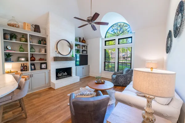 a living room with furniture a fireplace and a flat screen tv