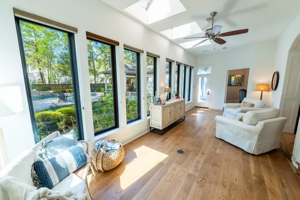 a living room with furniture and a wooden floor