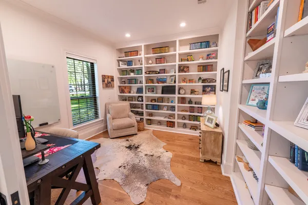 a living room with furniture a flat screen tv and a large window