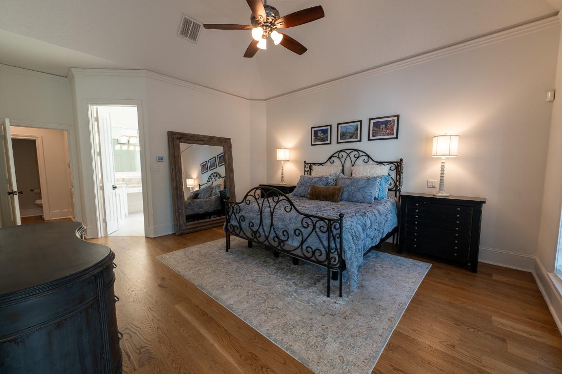 6 Red Sable Point The Woodlands, TX 77380 - Photo 21 of 50 a bedroom with a bed and wooden floor
