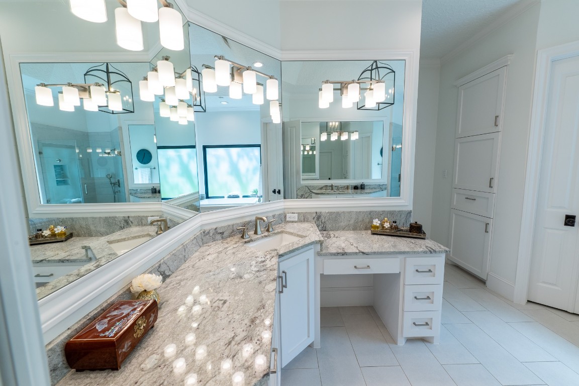 6 Red Sable Point The Woodlands, TX 77380 - Photo 22 of 50 a bathroom with a granite countertop sink a large mirror and a bathtub next to a window