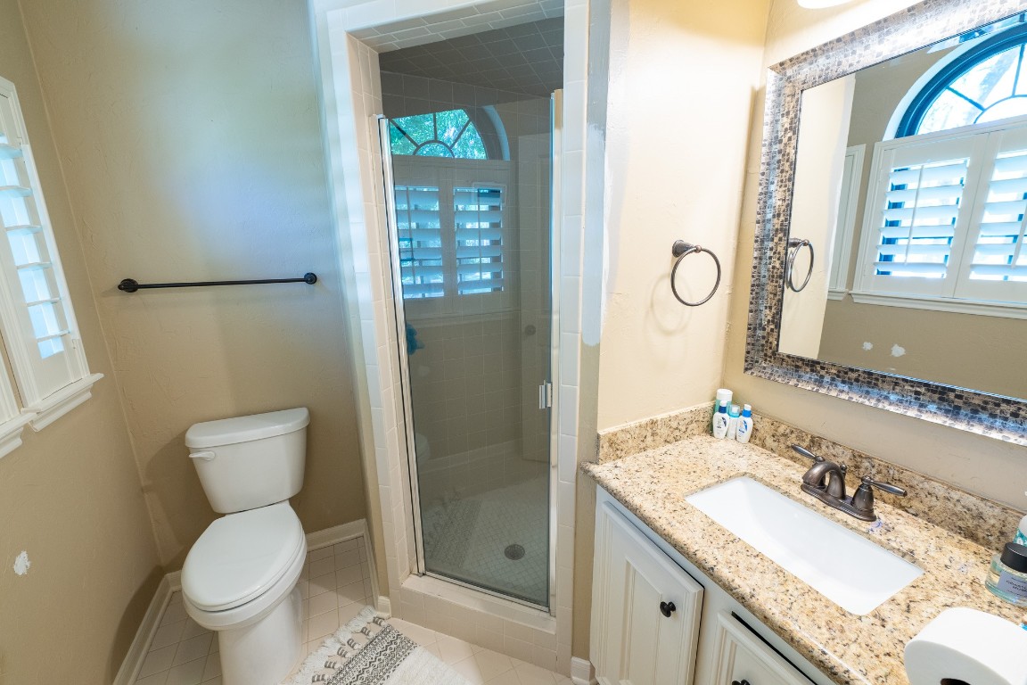 6 Red Sable Point The Woodlands, TX 77380 - Photo 27 of 50 a bathroom with a granite countertop toilet sink and mirror