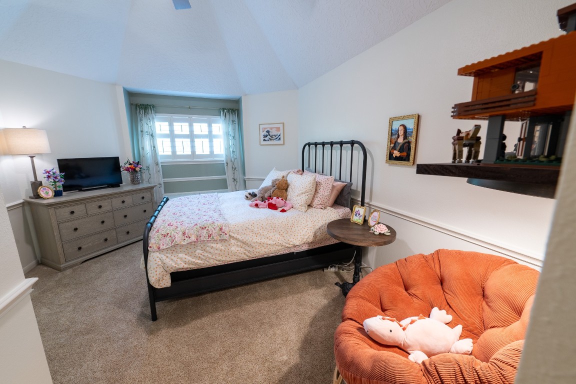 6 Red Sable Point The Woodlands, TX 77380 - Photo 28 of 50 a bedroom with a bed and a flat screen tv