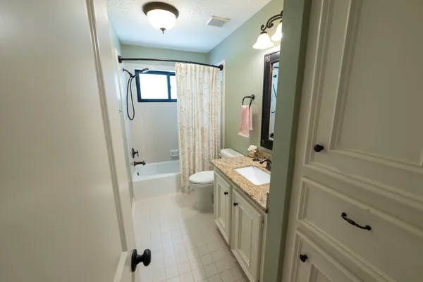a bedroom with two beds and a chandelier