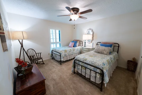 a bathroom with a granite countertop sink vanity mirror and shower