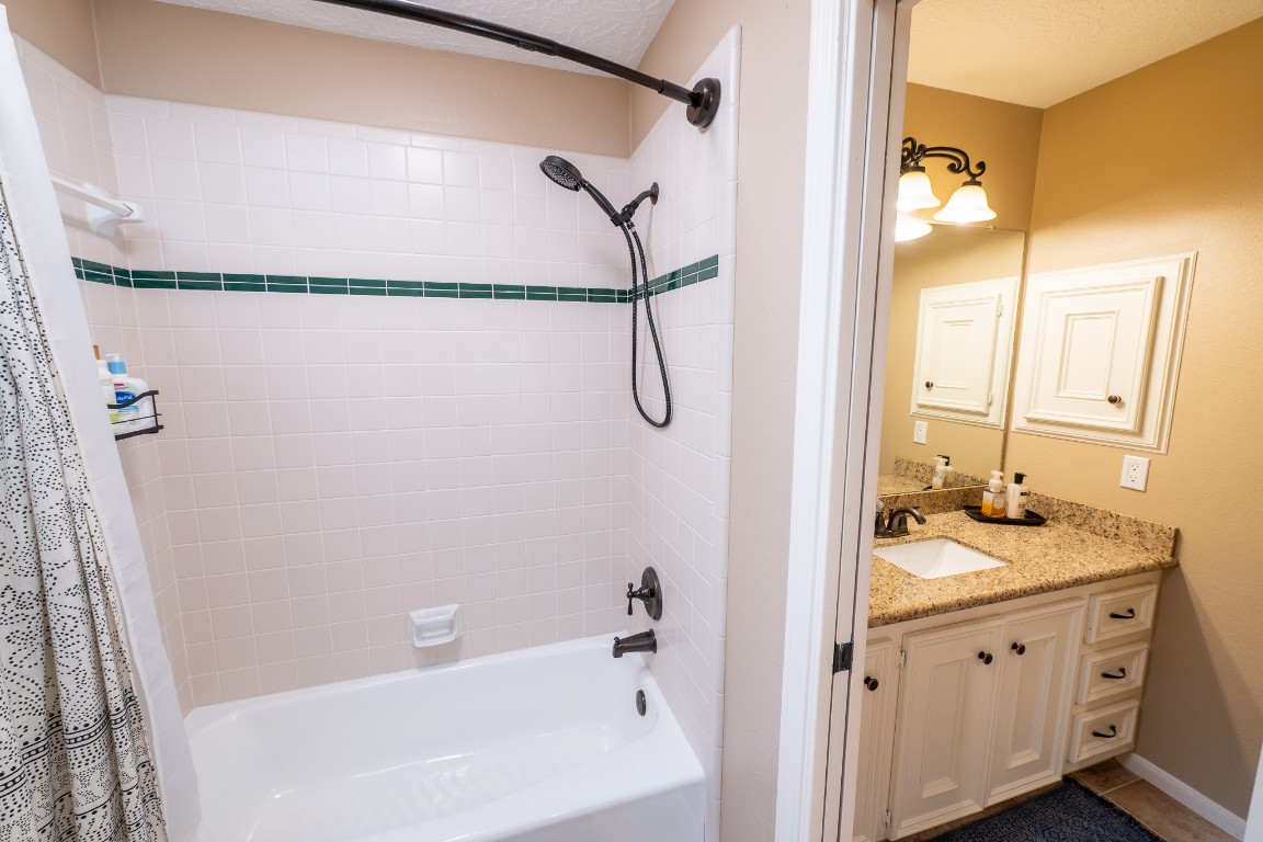 6 Red Sable Point The Woodlands, TX 77380 - Photo 32 of 50 a bathroom with a granite countertop sink vanity mirror and shower