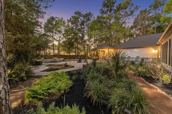 a swimming pool with outdoor seating and trees