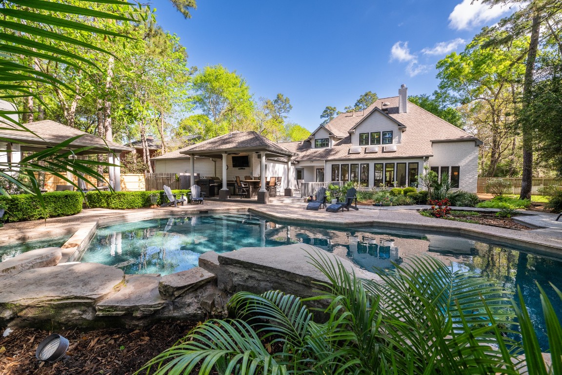 6 Red Sable Point The Woodlands, TX 77380 - Photo 35 of 50 a front view of a house with swimming pool having outdoor seating