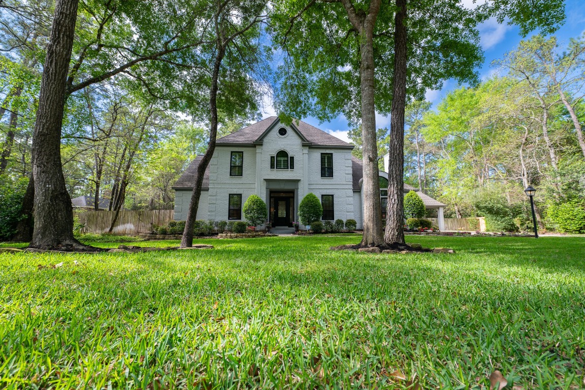 6 Red Sable Point The Woodlands, TX 77380 - Photo 5 of 50 a view of a house with a big yard and large trees
