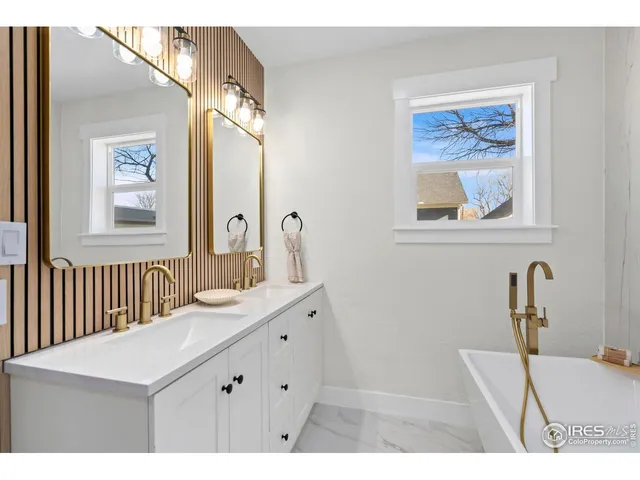 a bathroom with a sink a vanity and a mirror