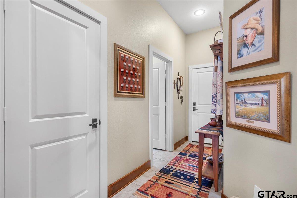 24050 Red Azalea Lindale, TX 75771 - Photo 14 of 48 a view of a hallway with paintings on the wall