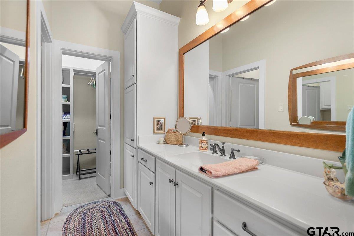 24050 Red Azalea Lindale, TX 75771 - Photo 29 of 48 a en suite bathroom with a sink and a mirror
