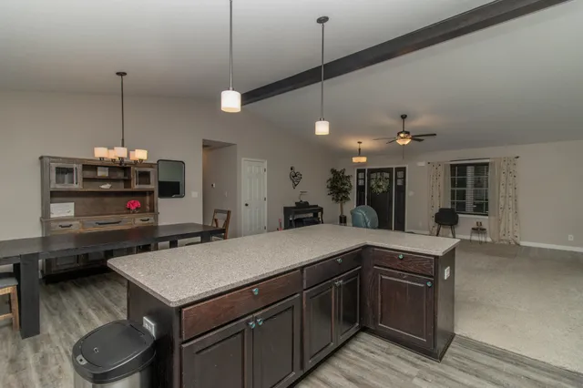 a kitchen with a stove a sink and a wooden floor
