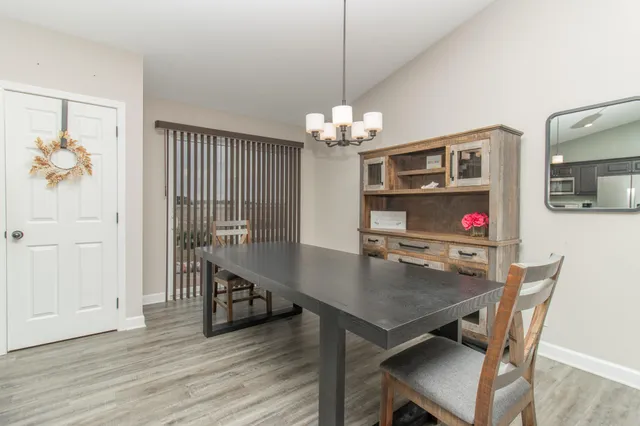 a view of a dining room with furniture wooden floor and chandelier