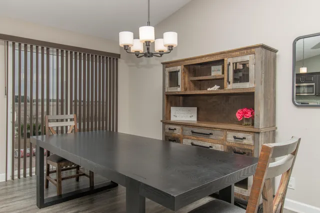a view of a dining room with furniture and chandelier