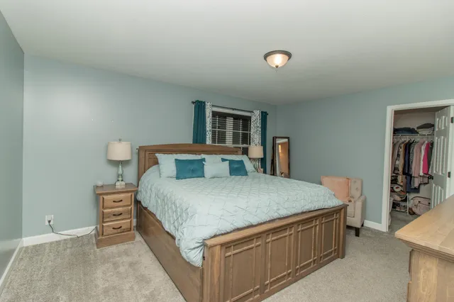 a bedroom with a bed and a television