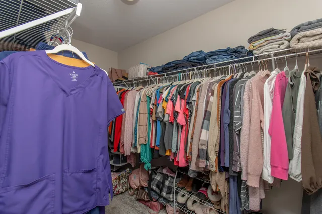 a view of walk in closet with clothes