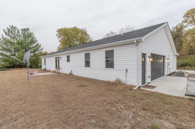 a view of a house with a backyard and a garage