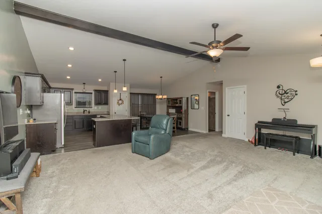a view of a kitchen with furniture and a ceiling fan
