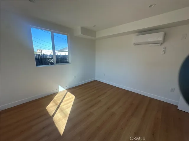 a view of a livingroom with wooden floor and windows