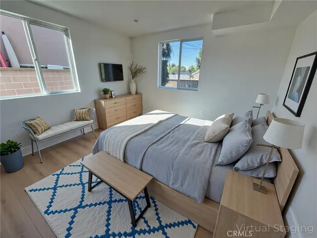 a bedroom with a bed a couch and dresser