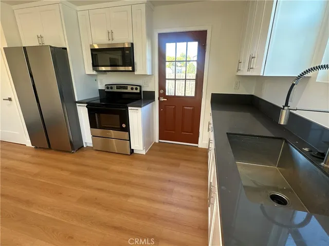 a kitchen with stainless steel appliances a refrigerator stove and microwave