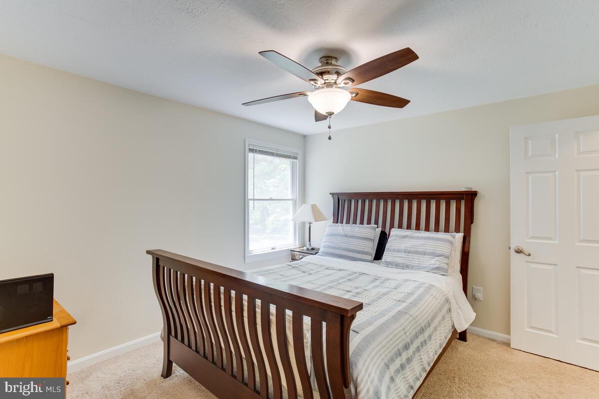 1260 Coster Road Lusby, MD 20657 - Photo 27 of 46 a bedroom with a large bed and a window