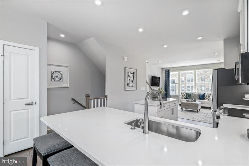 7181 Smoke Stack Road Baltimore, MD 21222 - Photo 3 of 20 a living room with kitchen island furniture and a large window