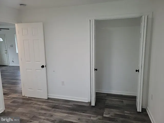 a view of wooden floor and windows in a room