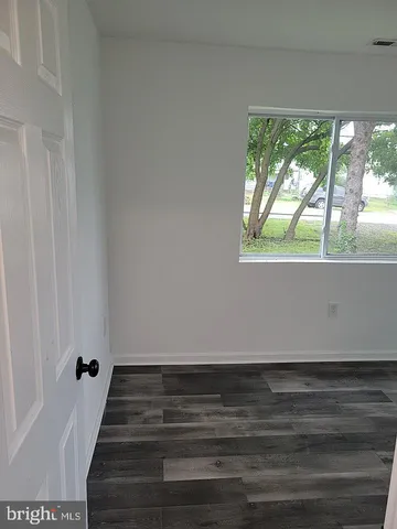 a view of wooden floor and windows in a room