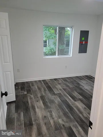 a view of a room with wooden floor and windows