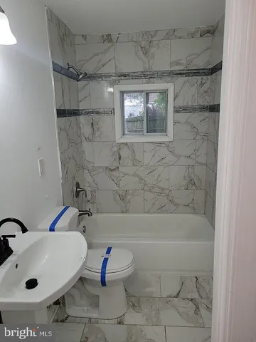 a bathroom with a sink mirror toilet and shower