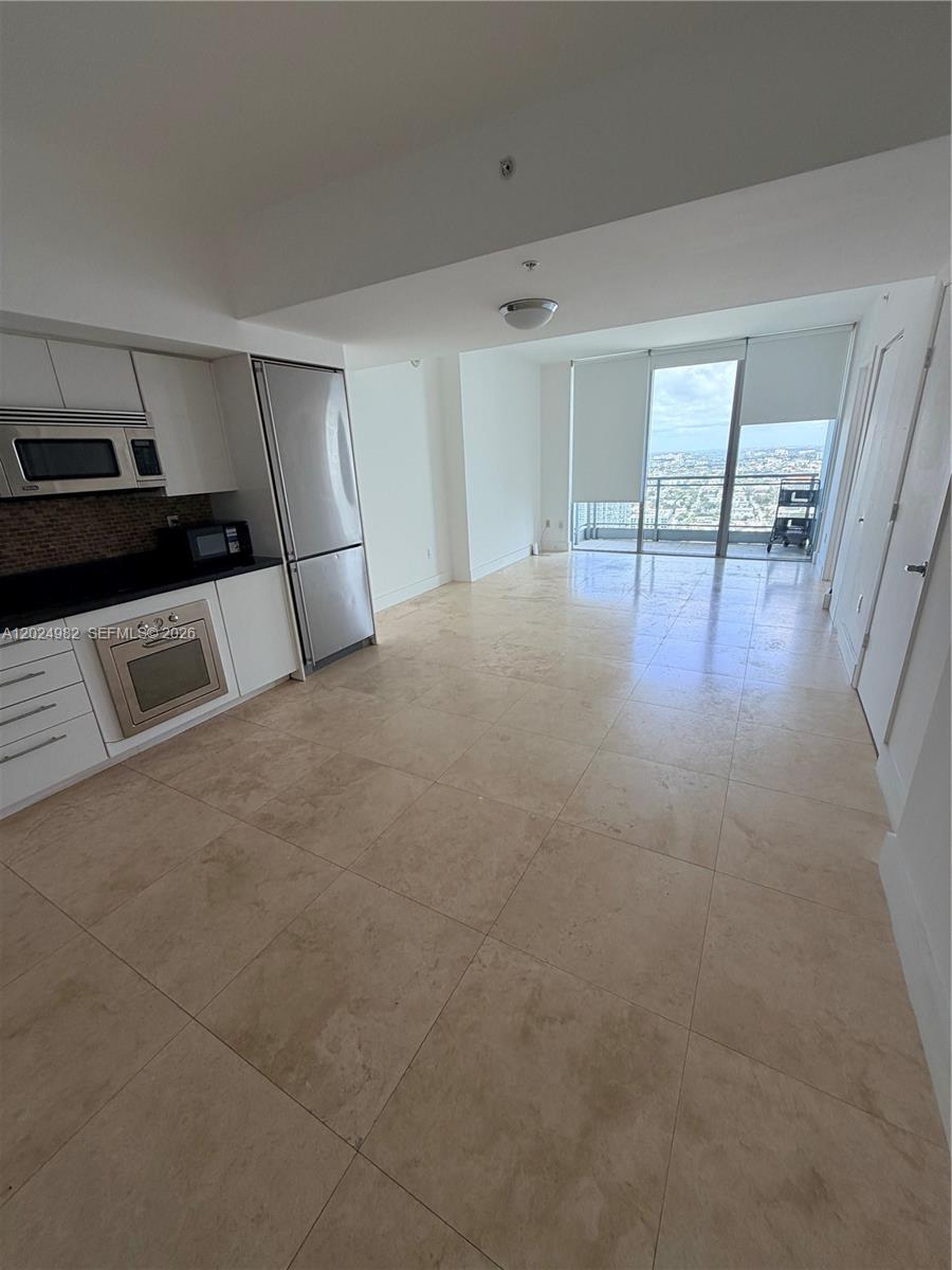 92 Southwest 3rd Street, Unit 3909 Miami, FL 33130 - Photo 1 of 13 a view of empty room with wooden floor
